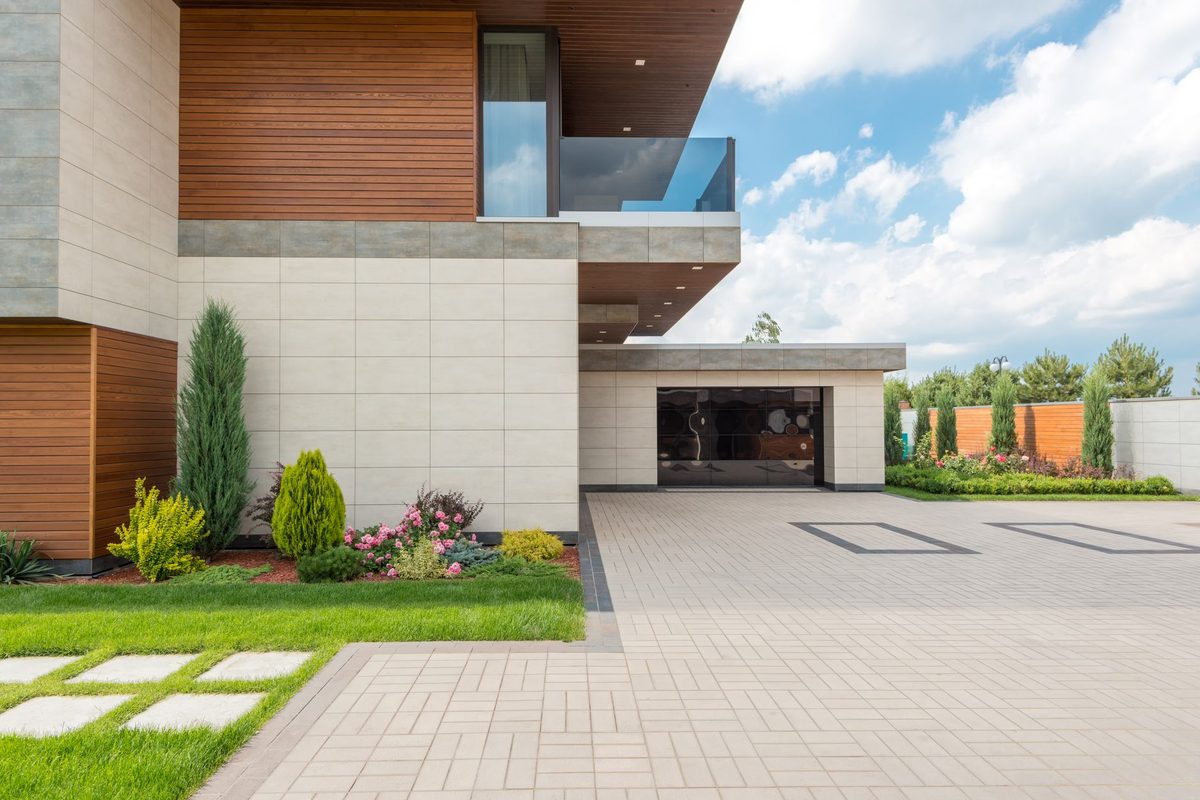 Modern home exterior with a paved driveway and attached garage